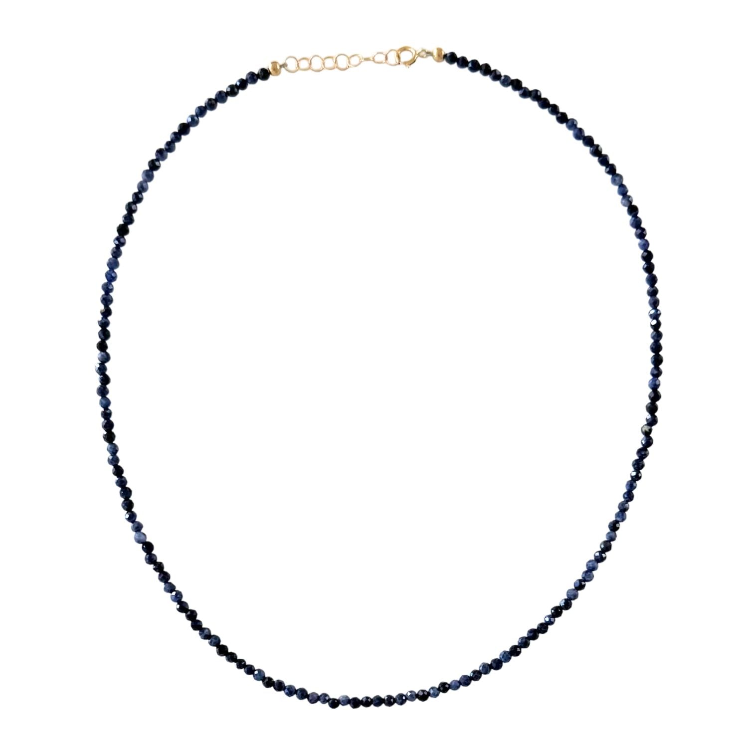 Necklace with dark blue sapphire beads on a white background