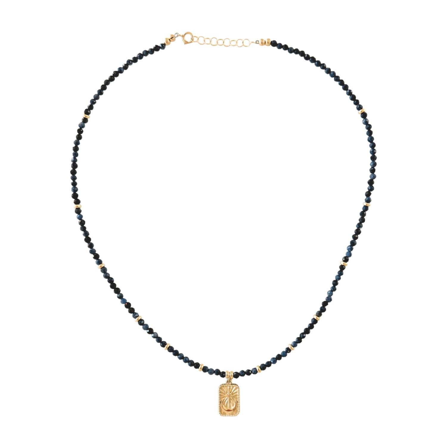 Necklace with blue sapphire beads and a gold celestial pendant on a white background