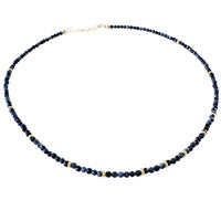 Necklace with blue beads on a white background
