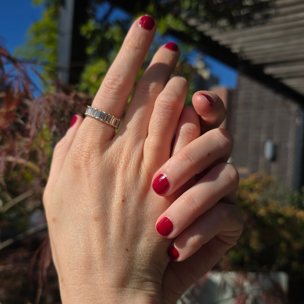 woman's hands modeling a diamond baguette eternity ring