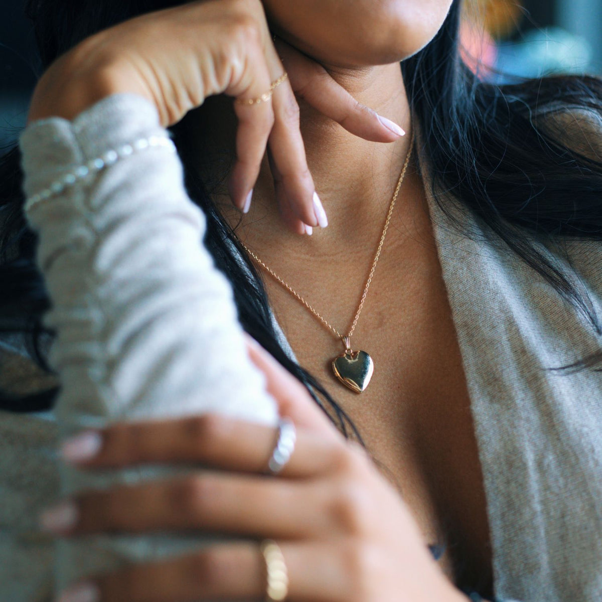 woman wearing a gold heart locket