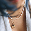 woman wearing a gold heart locket
