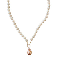 Pearl necklace with a gold chain and pink pendant on a white background