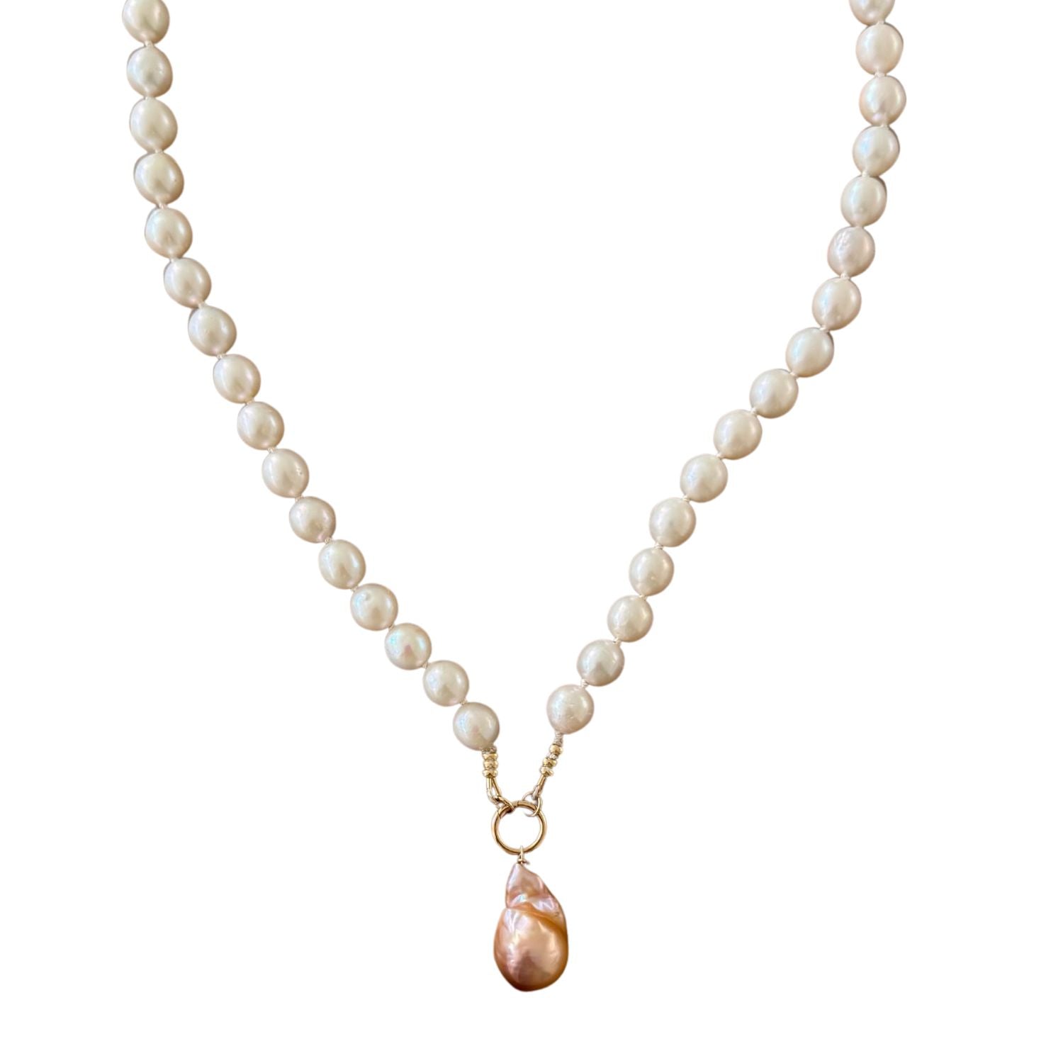 Pearl necklace with a gold chain and pink pendant on a white background