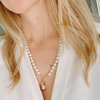 Freshwater Pearl necklace worn by a person with blonde hair, wearing a white top.