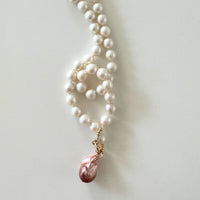 hand-knotted Pearl necklace with a pink pearl pendant on a light background