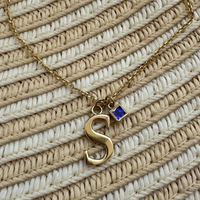 14k gold letter necklace with sapphire gem