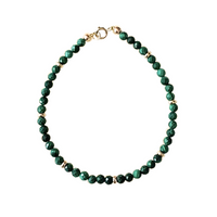 Green malachite beaded bracelet with 14k solid gold clasp on a white background