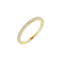 Gold ring with diamond accents on a white background