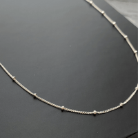 close up of sterling silver satellite chain necklace