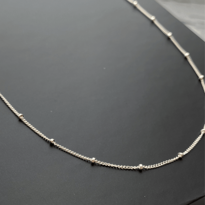 close up of sterling silver satellite chain necklace
