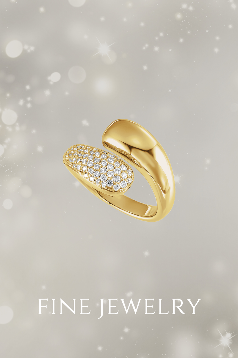 Gold ring with diamond accents on a soft snowy gray background