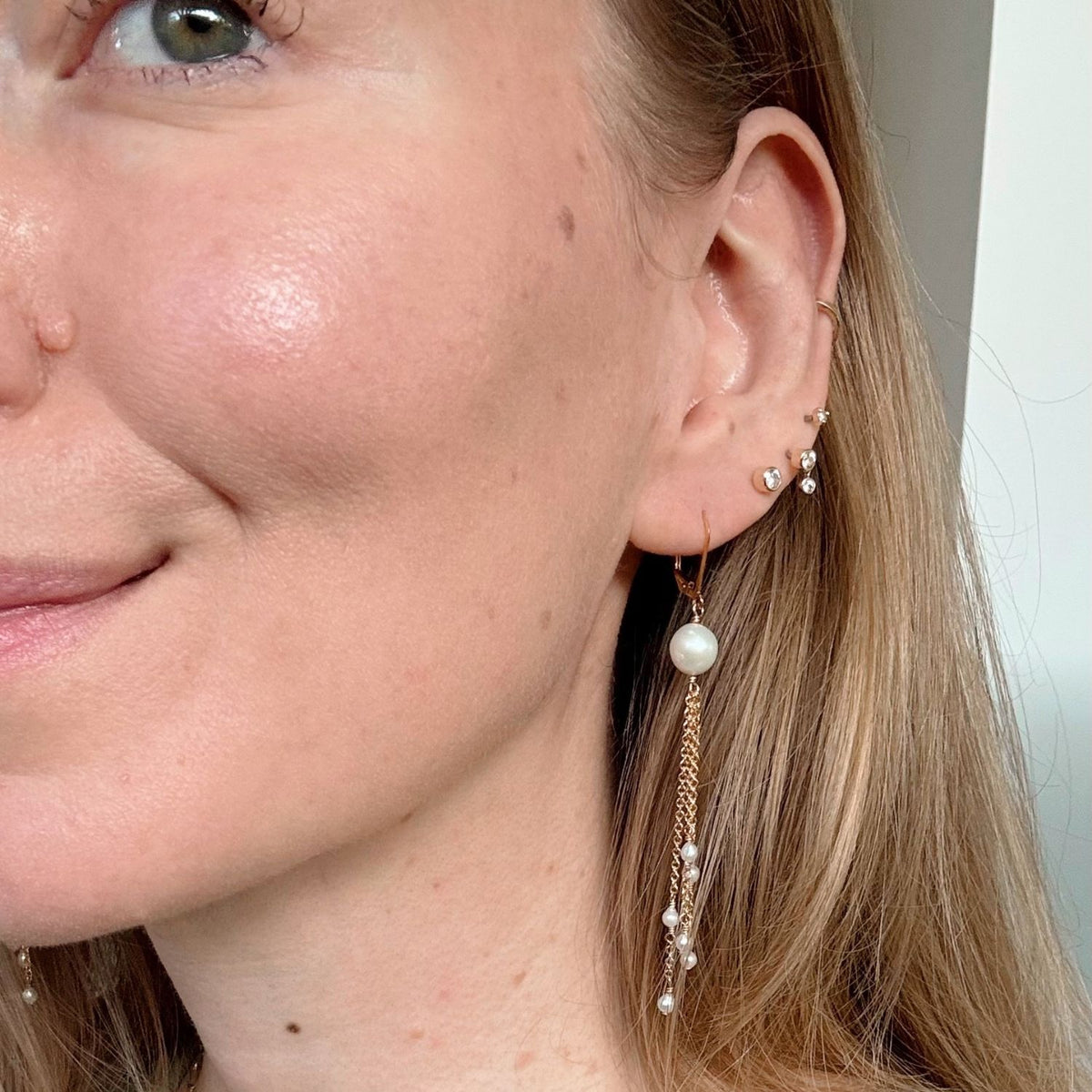 woman wearing freshwater pearl chain earrings