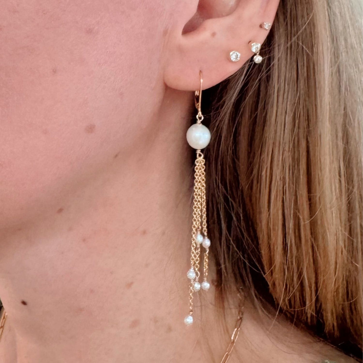 woman wearing gold filled freshwater pearl chain earrings 