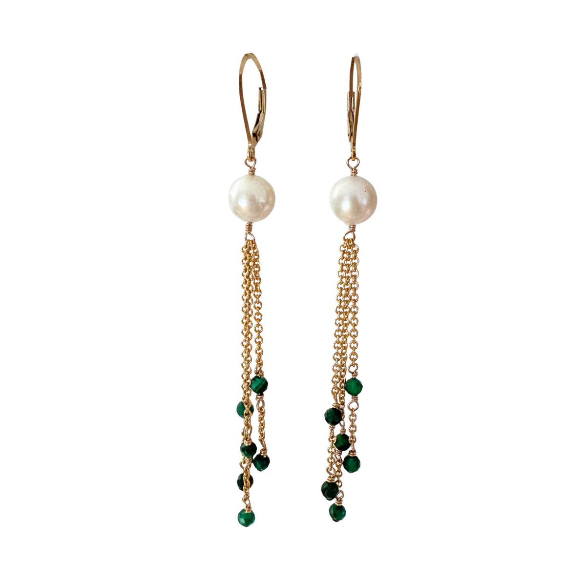 Pair of earrings with pearls and green beads on gold chains against a white background