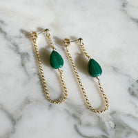 Malachite Stone Earrings with Gold Chain on marble background