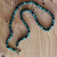 Green Agate bead necklace on wood background