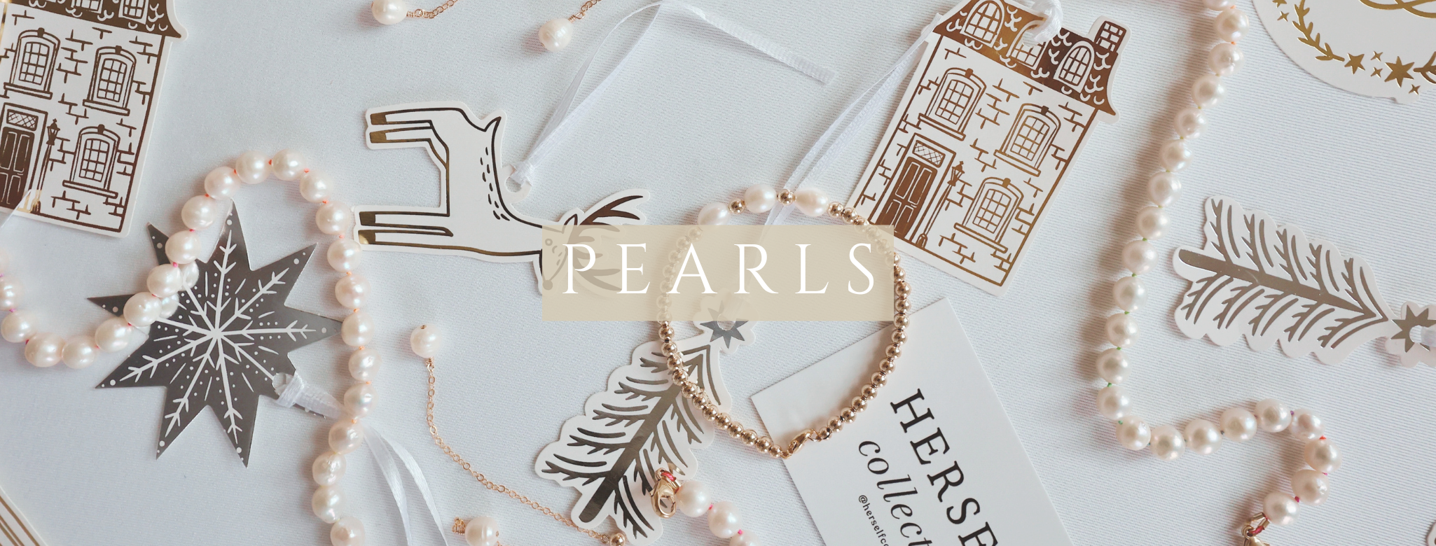 Holiday decorations with pearls and gold accents on a light background