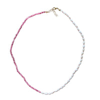 Necklace with pink beads and ivory pearls on a white background