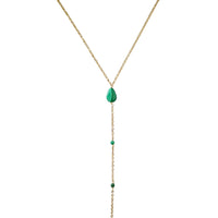 Gold necklace with green gemstones on a white background