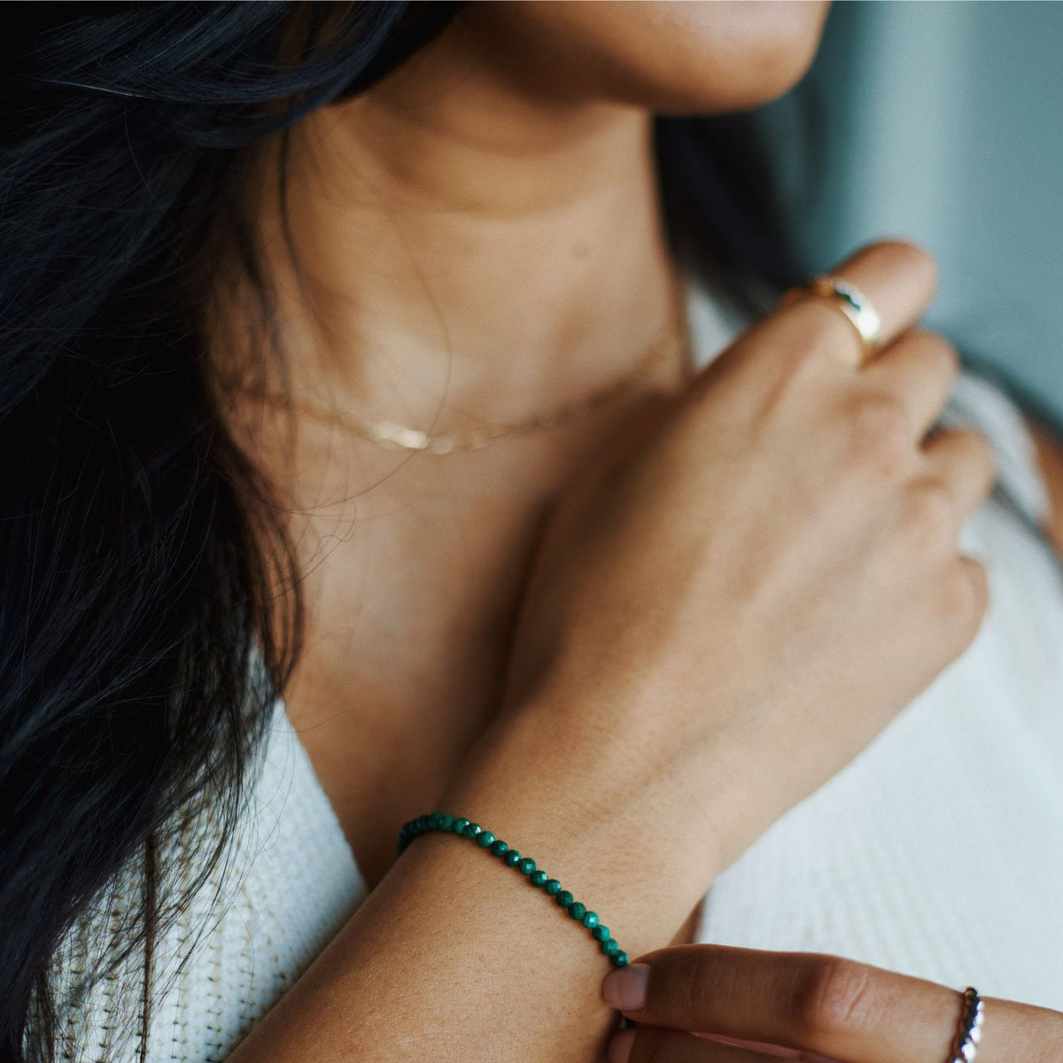 woman wearing 14k gold malachite bracelet