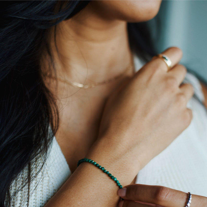 woman wearing 14k gold malachite bracelet